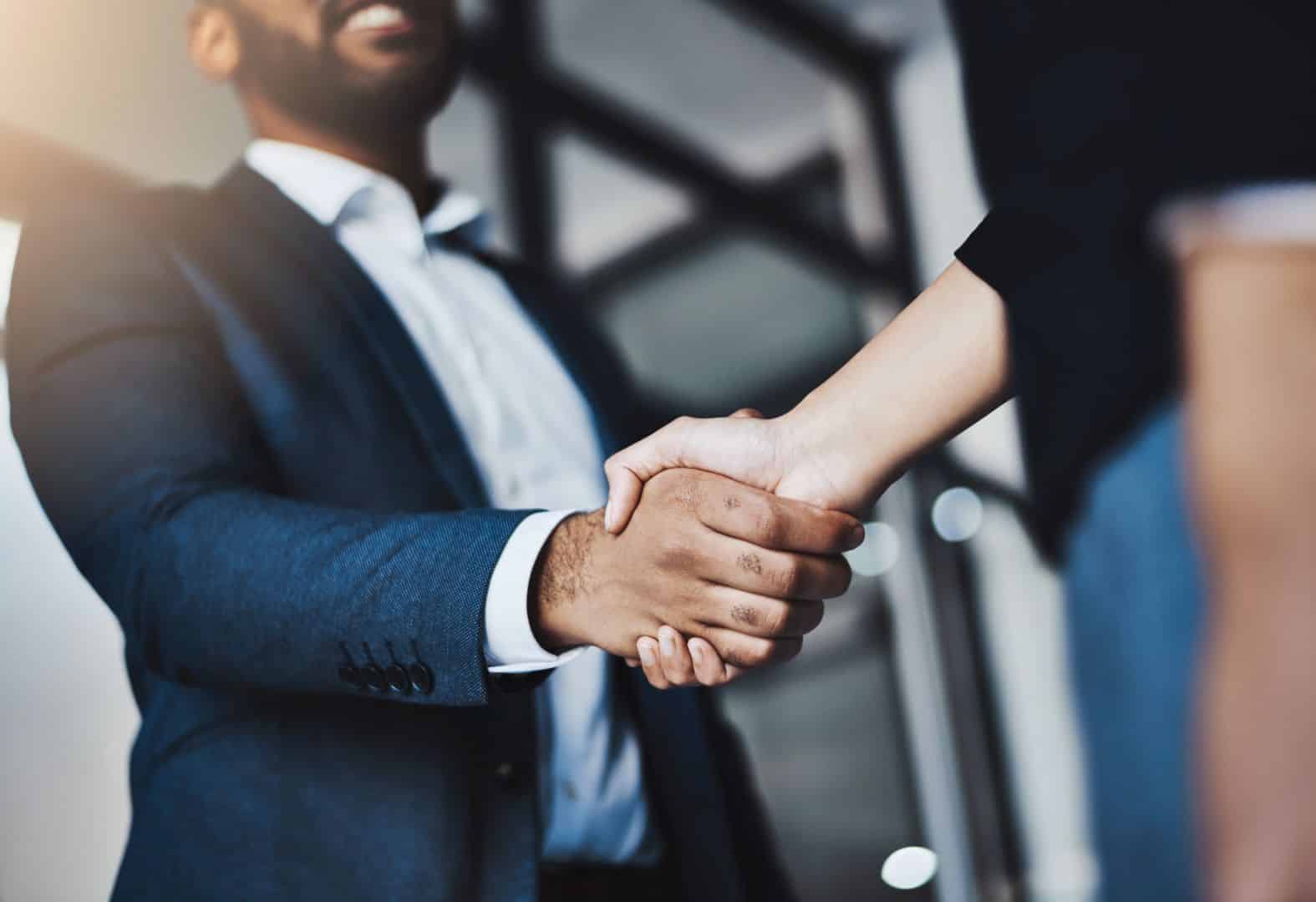 Closeup shot of two unrecognizable businesspeople shaking hands in an office
